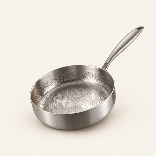 Hand-Hammered High-Wall Titanium Pan on a warm cream background
